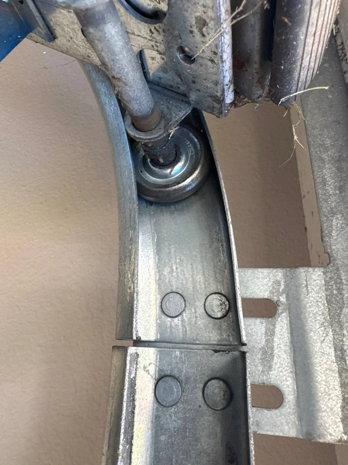 Close-up of garage door roller and track hardware