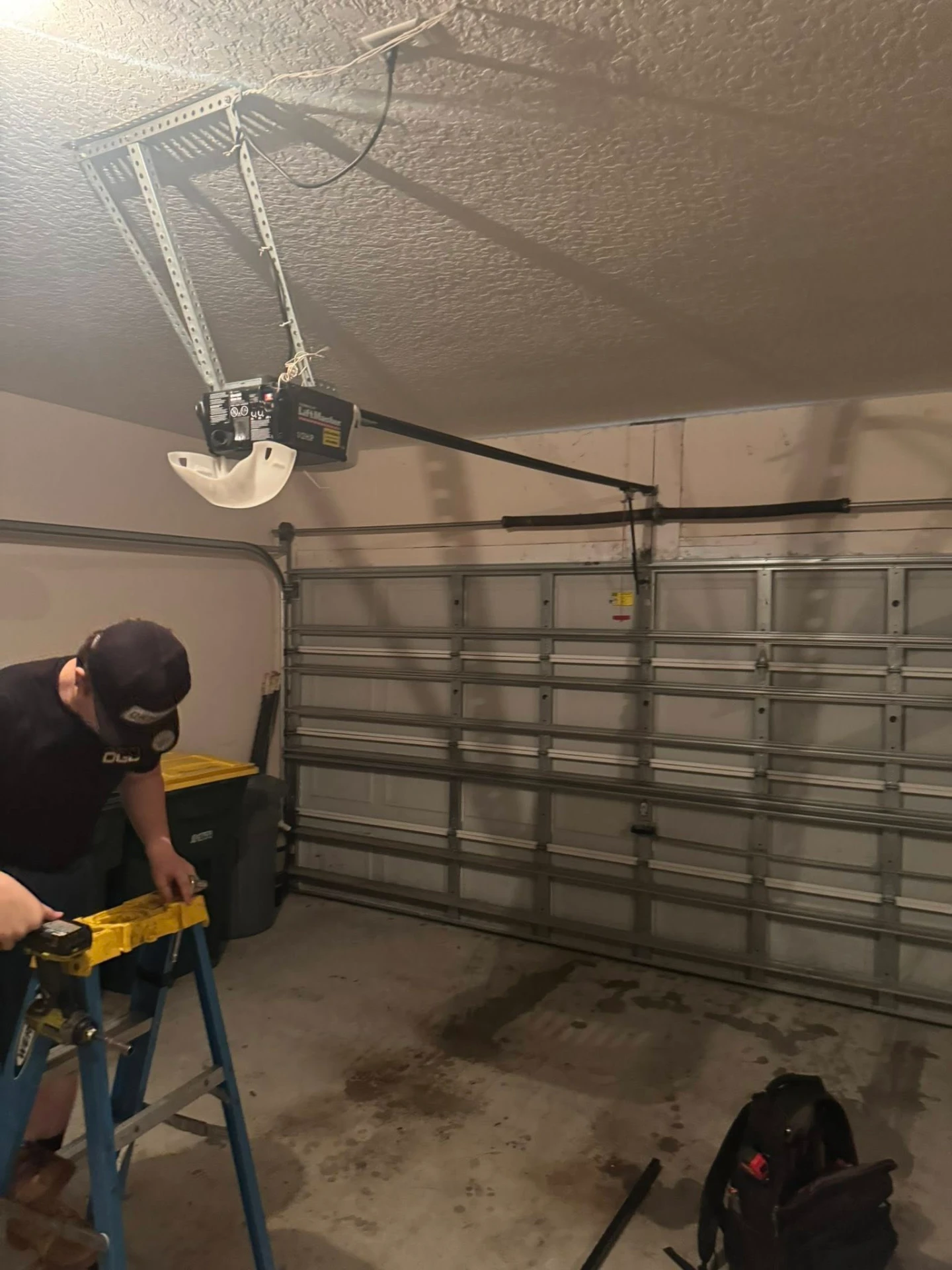 Technician working on LiftMaster garage door opener installation